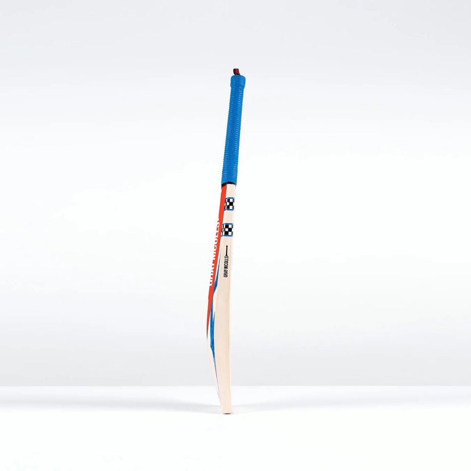 The Gray Nicolls Havoc 1.0 Test Cricket Bat 2026, featuring a blue grip and red-blue accents, stands upright against a plain white background.