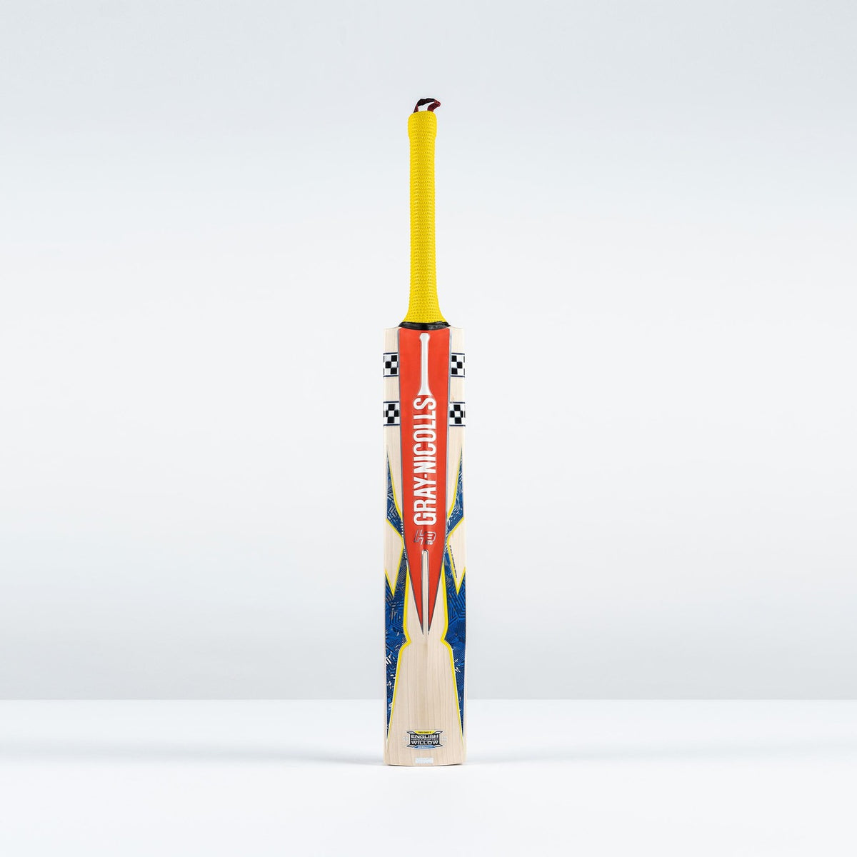 The Gray Nicolls Havoc HB317 Pro Edition SH 2026 cricket bat, featuring a mid-blade profile, yellow grip, and orange-blue accents with Gray Nicolls branding, stands upright against a plain white background.