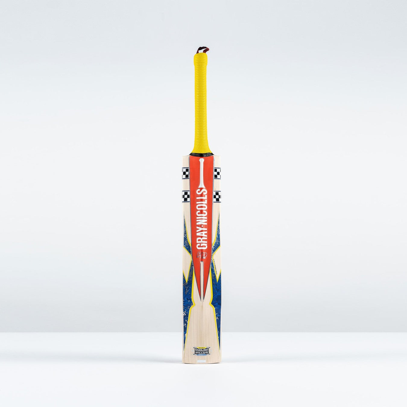 The Gray Nicolls Havoc HB317 Pro Edition SH 2026 cricket bat, featuring a mid-blade profile, yellow grip, and orange-blue accents with Gray Nicolls branding, stands upright against a plain white background.