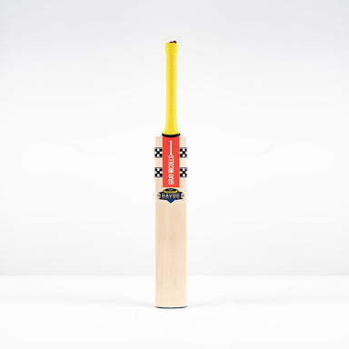 A Gray Nicolls Havoc HB317 Test SH 2026 bat with a yellow handle, red branding, and black-and-white checkered upper blade stands upright against a plain white background.