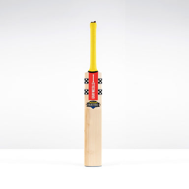 A Gray Nicolls Havoc HB317 GN550 Junior Cricket Bat 2026 with a yellow grip and black-and-white checkered accents stands upright against a plain white background, ready for dynamic strokes.