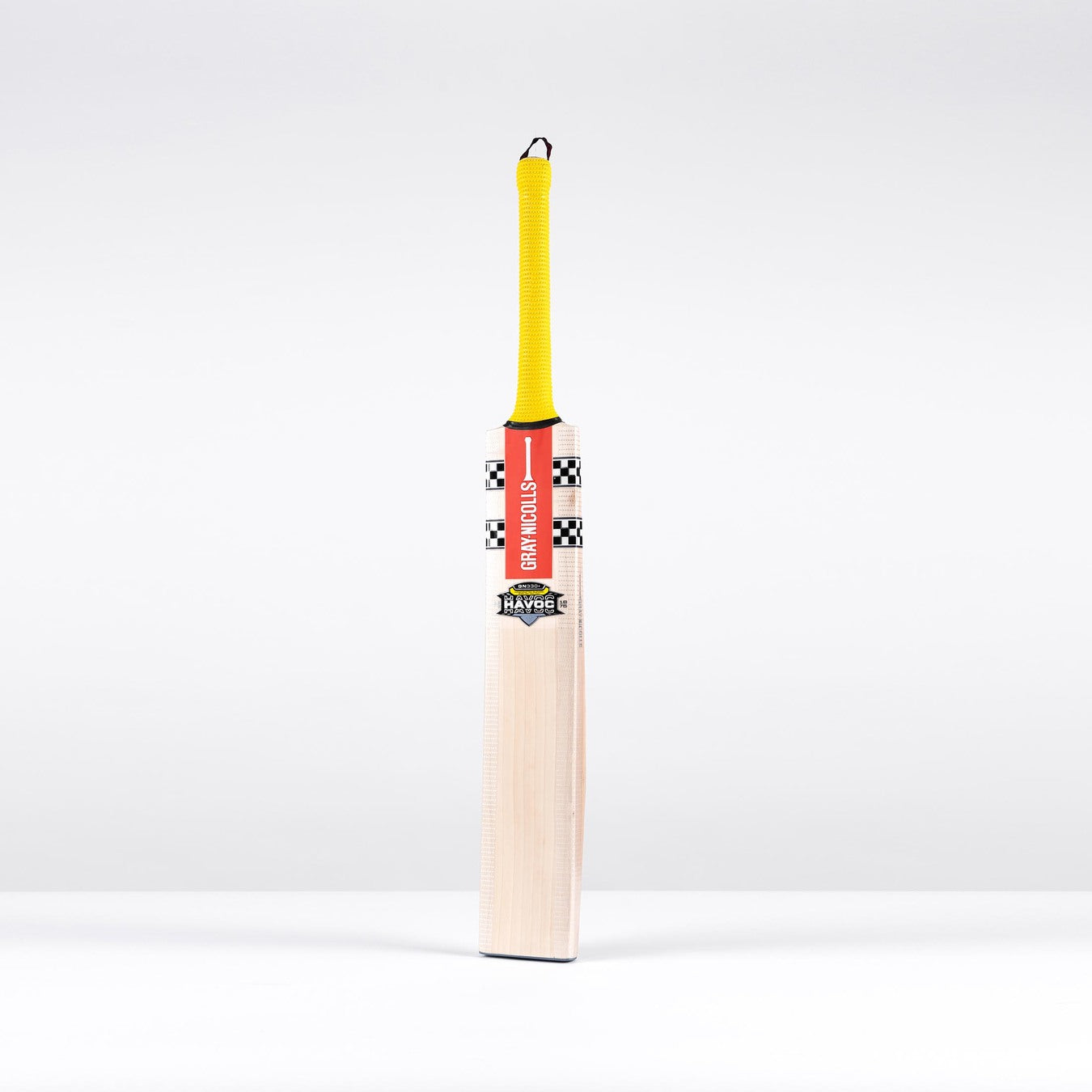 The Gray Nicolls Havoc HB317 GN330+ SH 2026 cricket bat, featuring a yellow grip, red and black label, and flat face, stands upright against a plain white background.