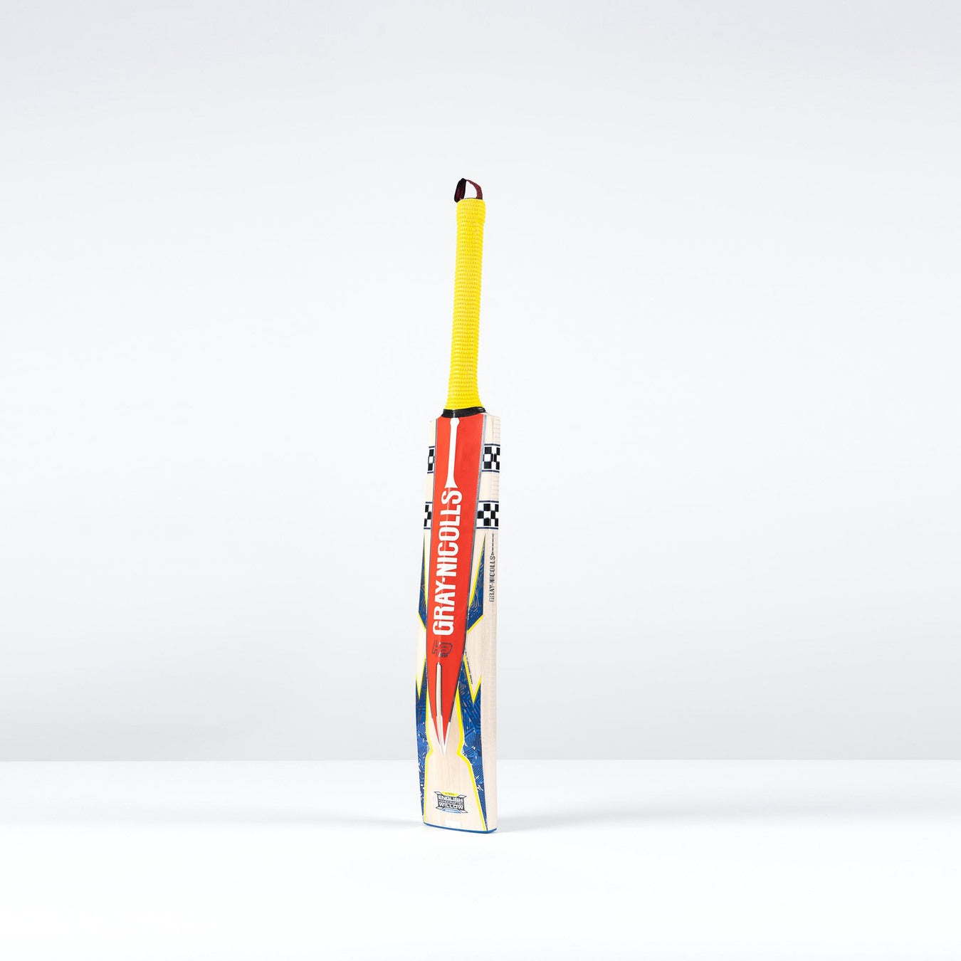 The Gray Nicolls Havoc HB317 GN330+ Junior Cricket Bat 2026 features an ultra-light pickup, yellow handle, and red/blue design. It stands upright on a white surface against a plain white background.