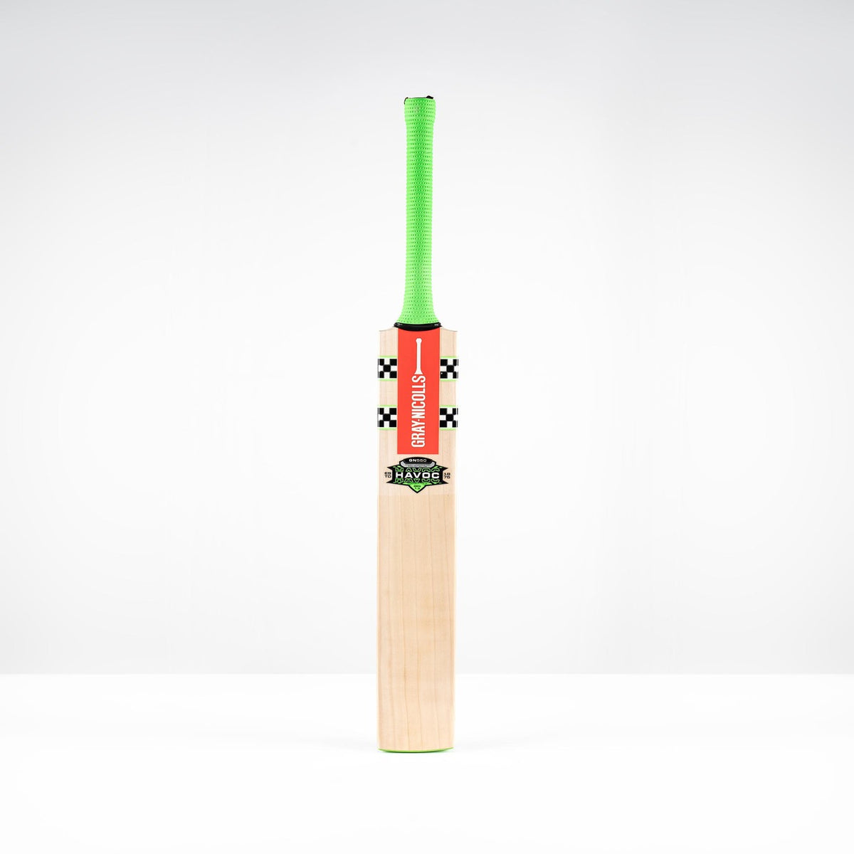 The Gray Nicolls Havoc 1.3 GN550 Junior Cricket Bat 2026, featuring a light blade, green handle, and red front branding, stands upright against a plain white background.