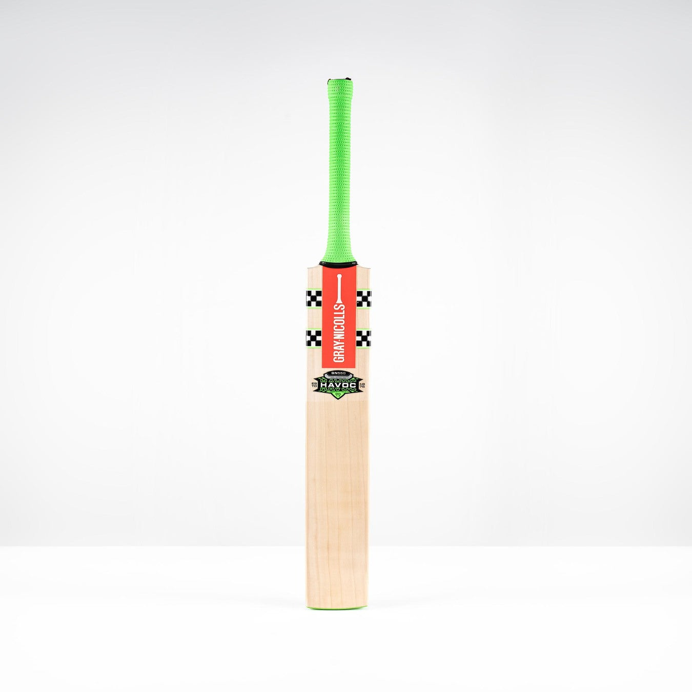The Gray Nicolls Havoc 1.3 GN550 Junior Cricket Bat 2026, featuring a light blade, green handle, and red front branding, stands upright against a plain white background.