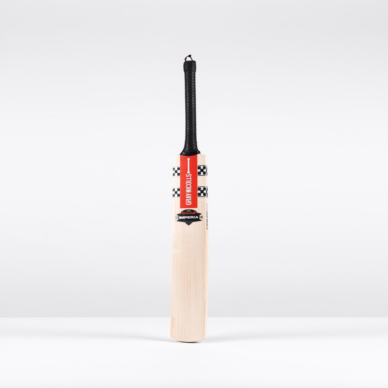 The Gray Nicolls Imperia 1.0 Pro V Lite SH 2026 cricket bat, featuring a black handle, red and black checkered design at the top, and front branding, stands upright against a plain white background.