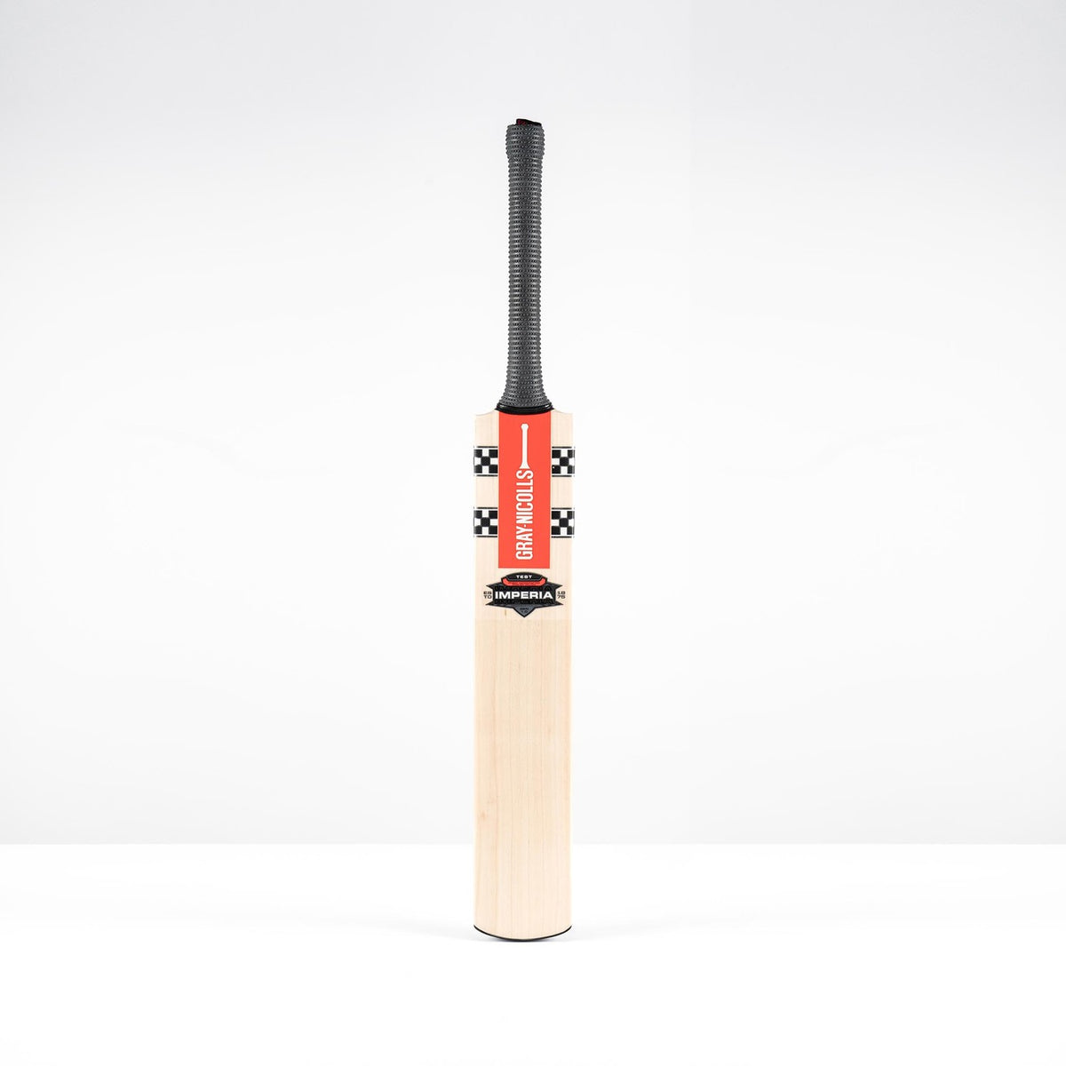 The Gray Nicolls Imperia 1.0 Test Cricket Bat 2026 features a black grip and red checkered label, standing upright against a plain white background.