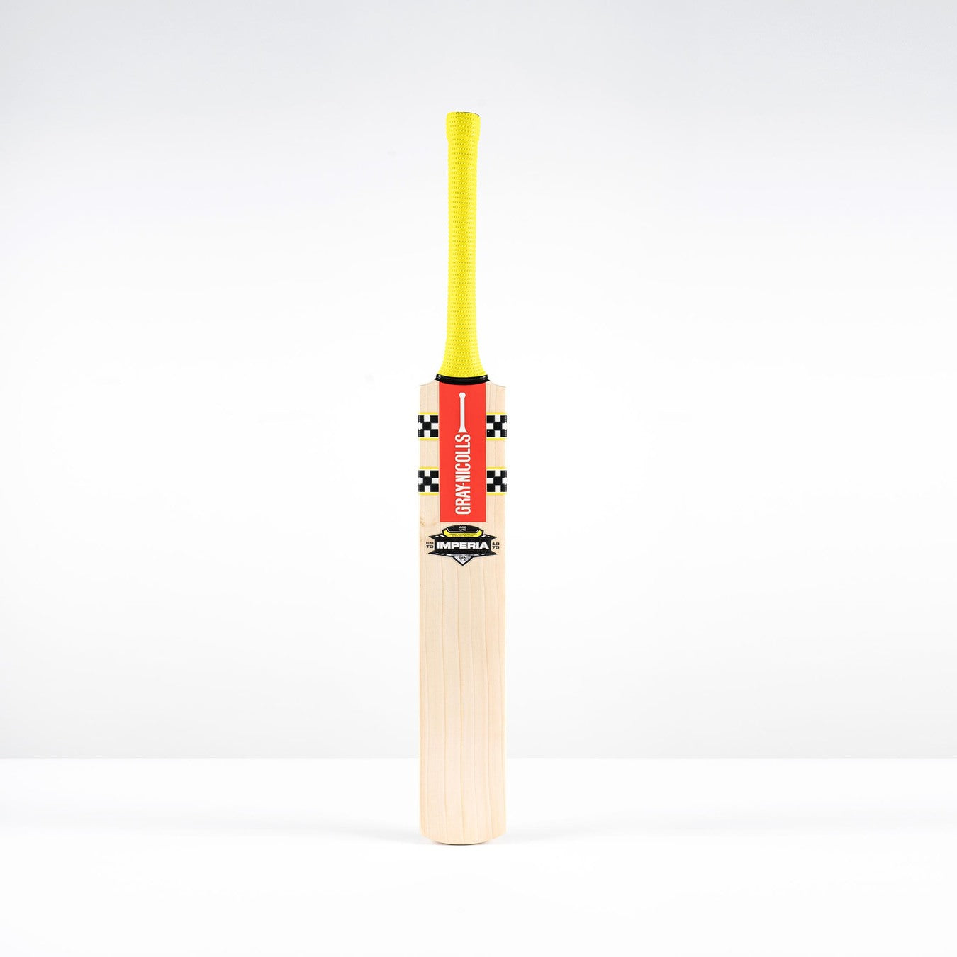 A Gray Nicolls Imperia 1.1 Pro Lite Junior Cricket Bat 2026 with a yellow grip and red label stands upright on a white background, ideal for young cricketers seeking a high-quality Pro Lite bat.