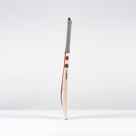 The Gray Nicolls Longbow Pro Junior Cricket Bat 2026, featuring a grey grip and red accents, stands upright against a white background. Designed by Gray Nicolls, it offers a mid-to-low sweet spot for young cricketers.