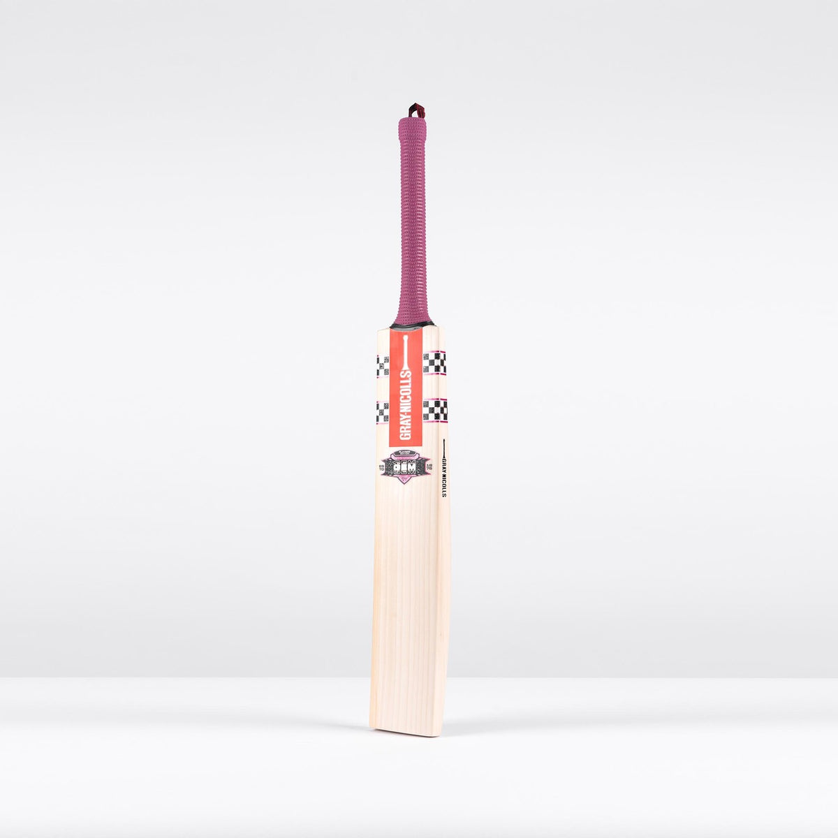 The Gray Nicolls GEM 3.1 Players Edition 2026 cricket bat stands upright on a plain white background, featuring a lightweight design, checkered and red label near the handle, and a purple grip for elite performance.