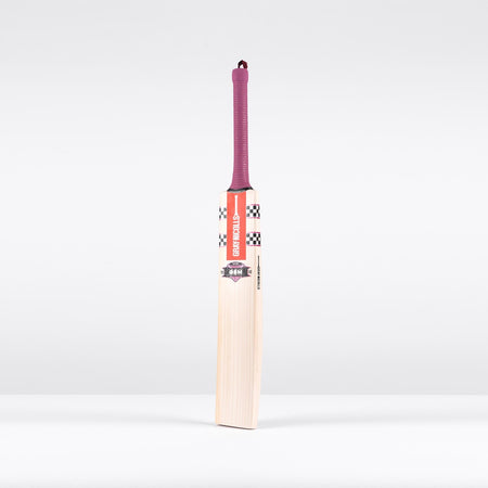 The Gray Nicolls GEM 3.1 Players Edition 2026 cricket bat stands upright on a plain white background, featuring a lightweight design, checkered and red label near the handle, and a purple grip for elite performance.