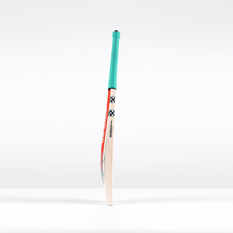 A single Gray Nicolls GEM 3.0 GN550 Cricket Bat 2026 stands upright on a white surface, showing its ultra-light blade, teal grip, and bold black, white, and red accents near the top.
