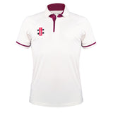 The Gray Nicolls Pro Performance V3 Short Sleeve Shirt is a white cricket polo with maroon trim on the collar and sleeves, featuring the Gray Nicolls logo on the left chest. Its moisture-wicking fabric keeps you comfortable all day.