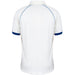 Back view of the Gray Nicolls Old Down CC Juniors - Matrix V2 Short Sleeve Match Shirt: a white, breathable polo with blue trim on the sleeve cuffs, blue piping along the shoulders, collar, and no visible logos or designs.