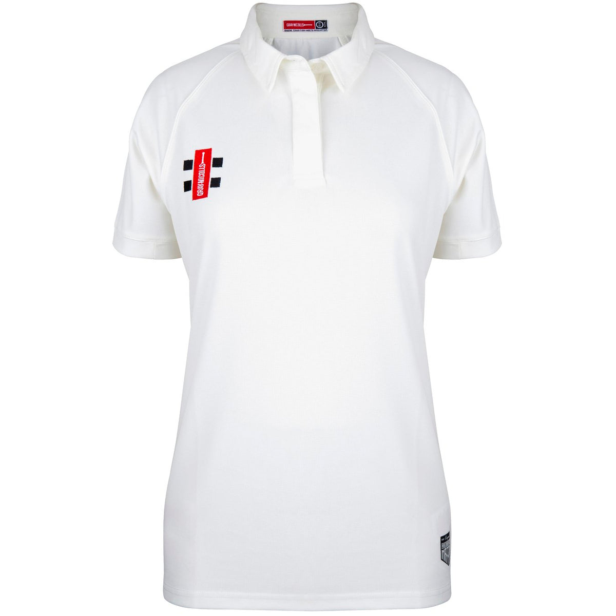 The Bushley CC Ladies Matrix V2 S/S Match Shirt by Gray Nicolls is a white, short-sleeve polo designed for breathability, featuring a classic collar, a small red and black logo on the left chest, and a subtle black label near the bottom hem for added style.