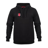 The Gray Nicolls Velocity Hoodie is a black sustainable hoodie with a front pocket, drawstring hood, and a small red and white rectangular logo on the left chest, shown on a plain white background.