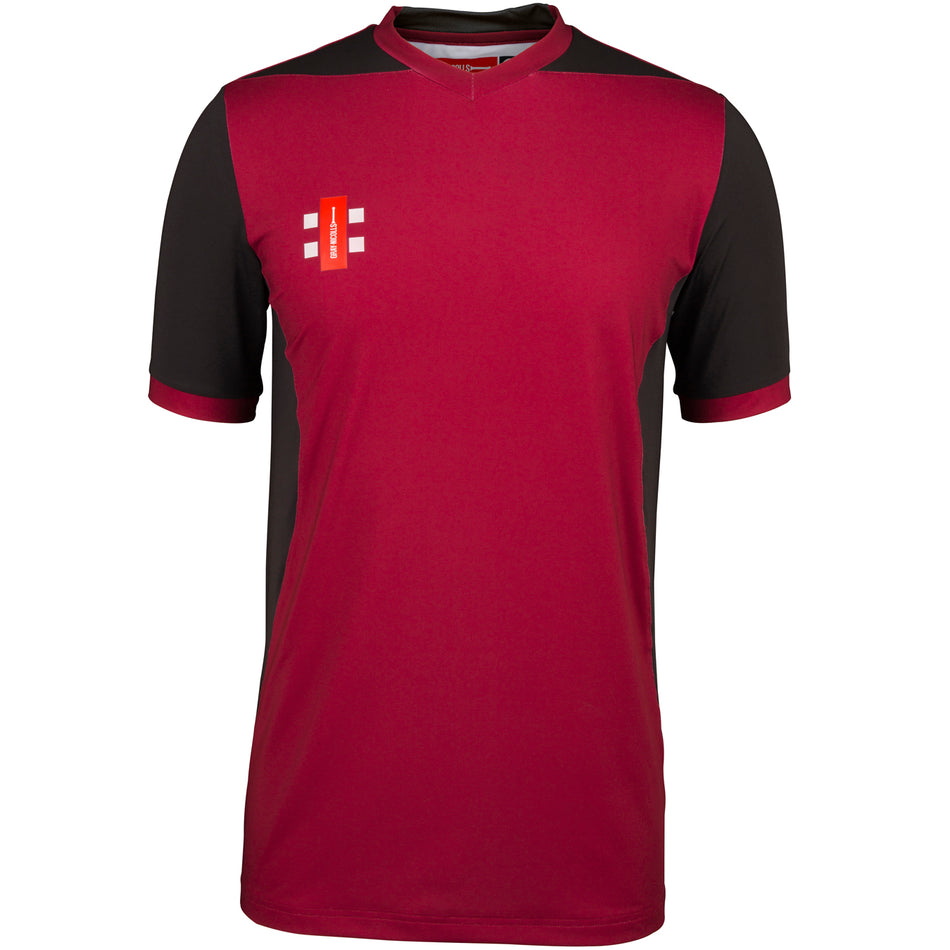 The Gray Nicolls Bushley CC Ladies T20 Match Shirt Short Sleeve features a maroon front, black sleeves and sides, maroon collar and cuffs, plus a white and orange chest logo. Made from moisture-wicking sportswear for comfort.