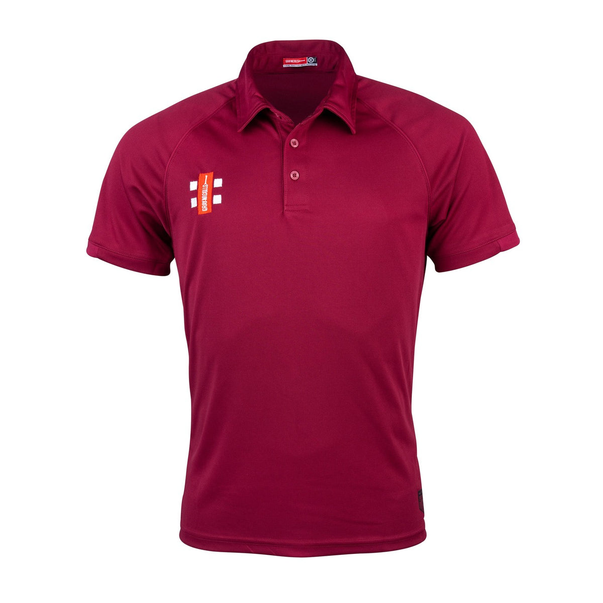 The Gray Nicolls Corse & Staunton CC Junior Matrix V2 Polo Shirt is maroon with short sleeves, a collar, and three buttons. Made from moisture-wicking fabric, it features a small white and red chest logo. Displayed on a plain white background.