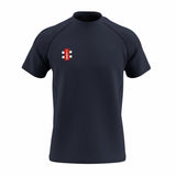 The Gray Nicolls GTS Junior S/S Tee Shirt is a dark navy performance T-shirt with short sleeves, a crew neck, and a small red and white rectangular logo on the left chest. Made from technical fabric and shown on a white background.