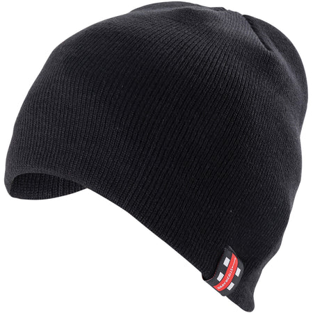 The Alvington & Woolaston CC Black Beanie Hat by Gray Nicolls is a black knit beanie with a small rectangular patch on the front displaying the club logo in red, white, and black.