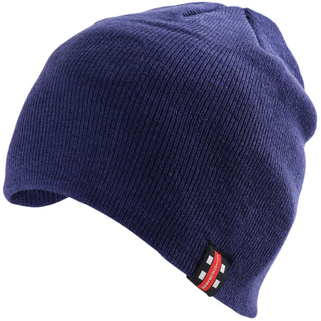 The Gray Nicolls Arcadians Nine Elms CC Beanie Hat is a classic navy beanie featuring a small black, white, and red tag on the folded edge, shown against a white background.