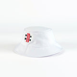 The Gray Nicolls Bucket Hat by Gray Nicolls is a white hat featuring a red vertical tag with black and white text and two sets of double black square designs on the front, shown against a plain white background.