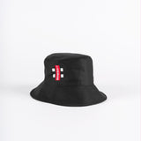 The Gray Nicolls Bucket Hat by Gray Nicolls is black with a red and white rectangular tag on the front, shown against a plain white background.