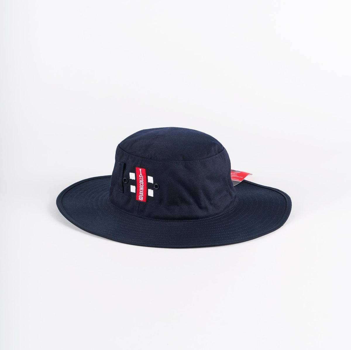 The Gray Nicolls Sun Hat in navy features two small metal eyelets and a red side tag with white text, and is displayed on a plain white background.
