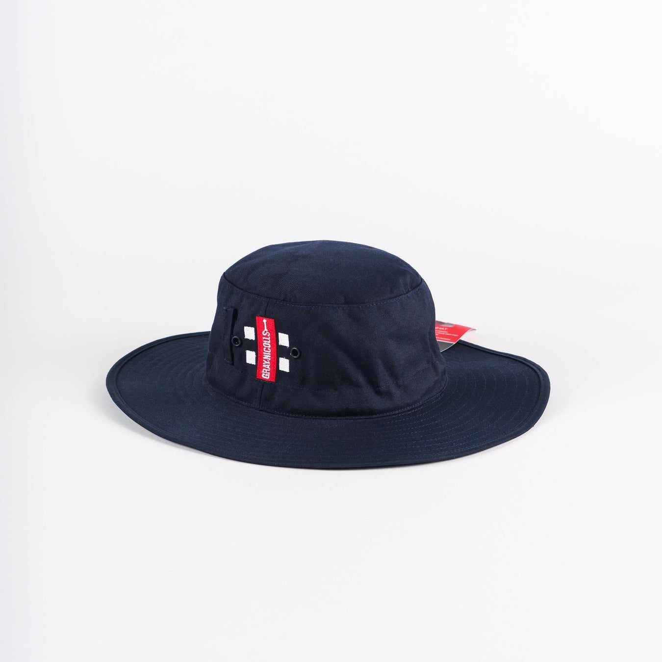 The Gray Nicolls Sun Hat in navy features two small metal eyelets and a red side tag with white text, and is displayed on a plain white background.