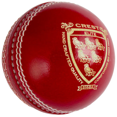 A close-up of the Gray Nicolls Crest Elite Cricket Ball, featuring shiny red chrome tanned leather with white stitching and a gold embossed Crest Elite Hand Crafted Quality logo beside an emblem with six birds.