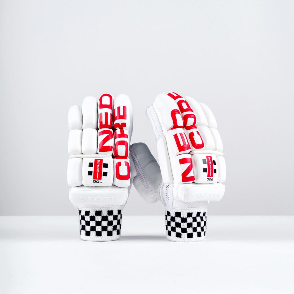 The Gray Nicolls Neocore 500 Batting Gloves 2026 feature a sleek white design with bold red "NEOCORE" branding, split finger construction, black-and-white checkerboard cuffs, and are showcased on a clean, minimal background.