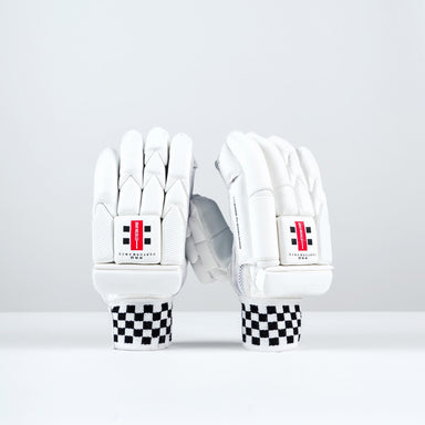 The Gray Nicolls Pro Performance Batting Gloves 2026 stand upright on a white surface, featuring black and white checkered wristbands and red logos, highlighting the classic design of these premium cricket gloves by Gray Nicolls.