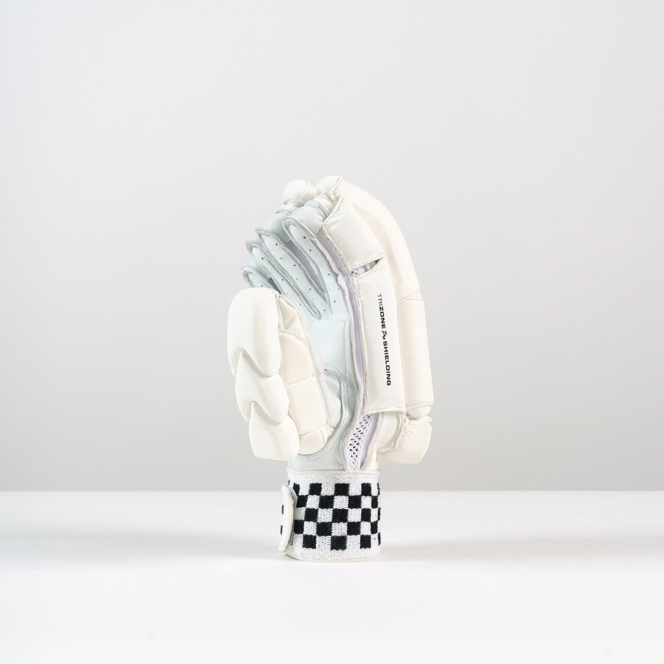 The Gray Nicolls Pro Performance Batting Glove 2026, featuring premium leather and black and white checkerboard wrist detail, is displayed upright against a plain white background.