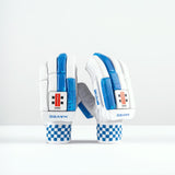 A pair of Gray Nicolls Havoc 1.0 350 Batting Gloves 2026 in white with blue accents and checkered wristbands stand upright on a white surface, showing finger protection and the Gray Nicolls brand name on the wrist.