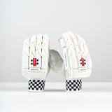 A pair of Gray Nicolls Classic Players Edition Batting Gloves 2026 in white are displayed upright on a plain white surface with black and white checkered wristbands and red labels, against a white background.