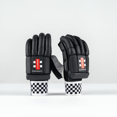The Gray Nicolls Ultimate 500 Coloured Batting Gloves 2026 in black feature pre-curved design, tri-layer protection, red and white branding on the back, and checkered black-and-white cuffs, displayed upright against a plain white background.