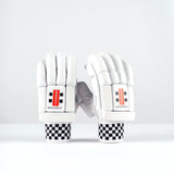 The Gray Nicolls Ultimate 500 Batting Gloves 2026 are white cricket gloves with tri-layer protection, padded fingers, black-and-white checkered wristbands, and a red and black wrist label, shown upright on a plain white background.