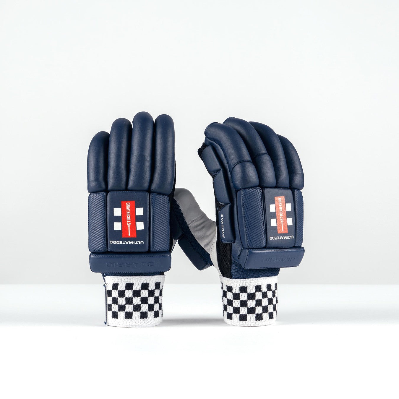 The Gray Nicolls Ultimate 500 Coloured Batting Gloves 2026 in navy feature padded fingers and palms, tri-layer protection, red and white wrist branding, and checkered cuffs. Displayed upright on a white surface.