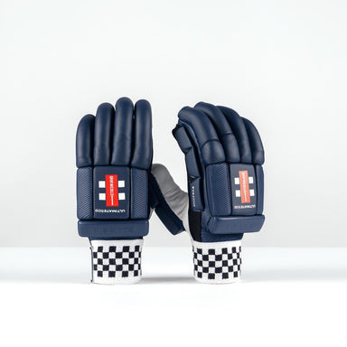The Gray Nicolls Ultimate 500 Coloured Batting Gloves 2026 in navy feature padded fingers and palms, tri-layer protection, red and white wrist branding, and checkered cuffs. Displayed upright on a white surface.