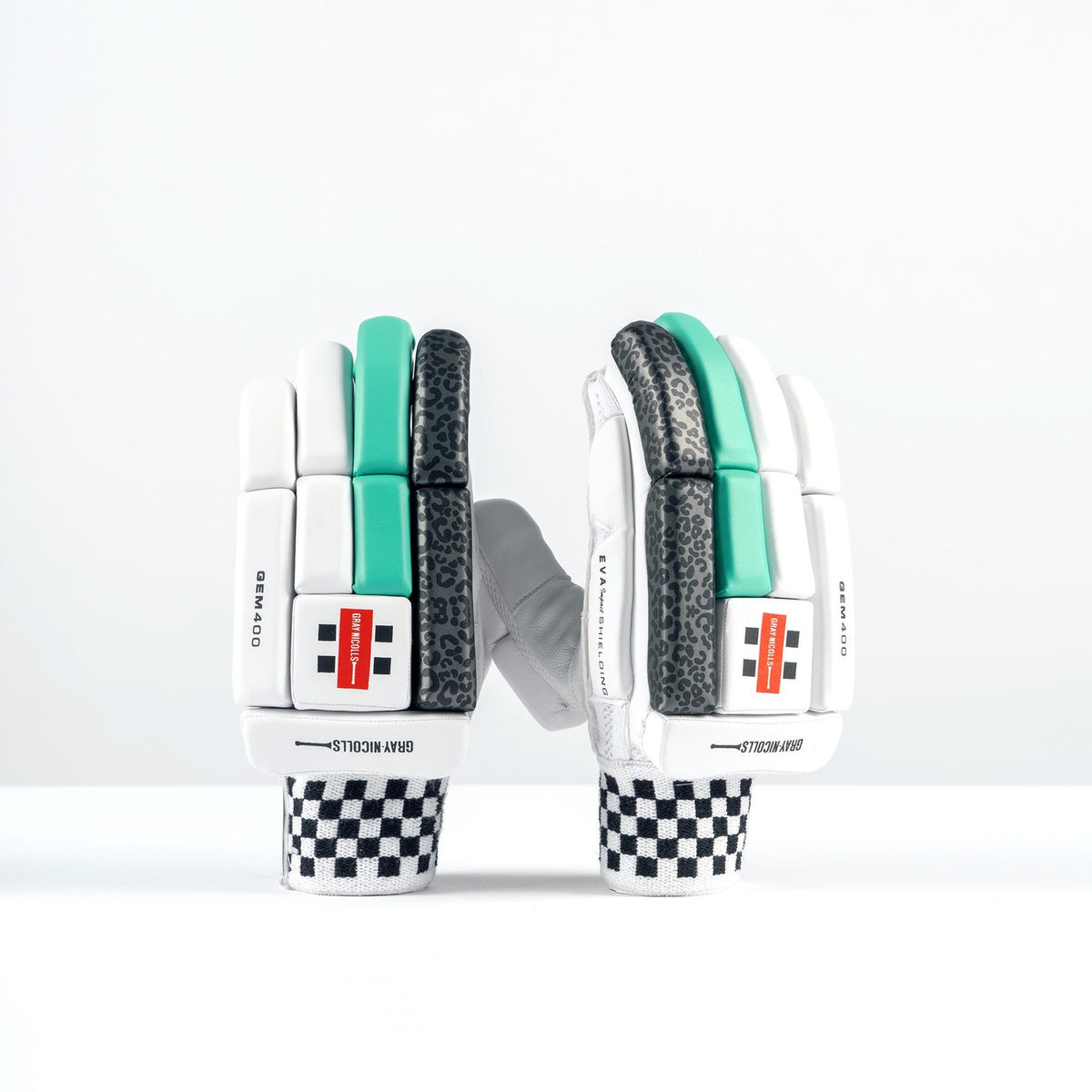 The Gray Nicolls GEM 3.1 400 Batting Gloves 2026 feature black-and-white checkered cuffs, white palms, and teal and black high-density foam padding, standing upright against a plain white background.