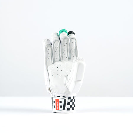 The Gray Nicolls GEM 3.1 400 Batting Gloves 2026, by Gray Nicolls, features high-density foam padding and a black-and-white checkered wristband. The glove stands upright, holding green poker chips against a plain white background.