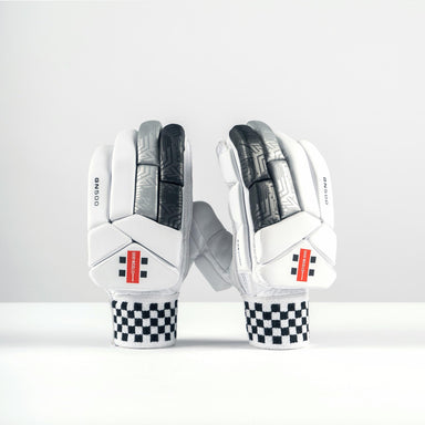 A pair of Gray Nicolls GN500X Batting Gloves 2026 featuring white, black, and gray high-density foam padding with black-and-white checkered wrist straps and red rectangular accents, displayed upright on a plain white surface.