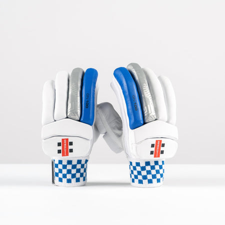 Gray Nicolls GN100X Batting Gloves 2026: white club cricket gloves with blue, gray, and silver finger padding, red Gray Nicolls branding on the wrist straps, and blue-and-white checkered cuffs, shown upright on a plain white background.
