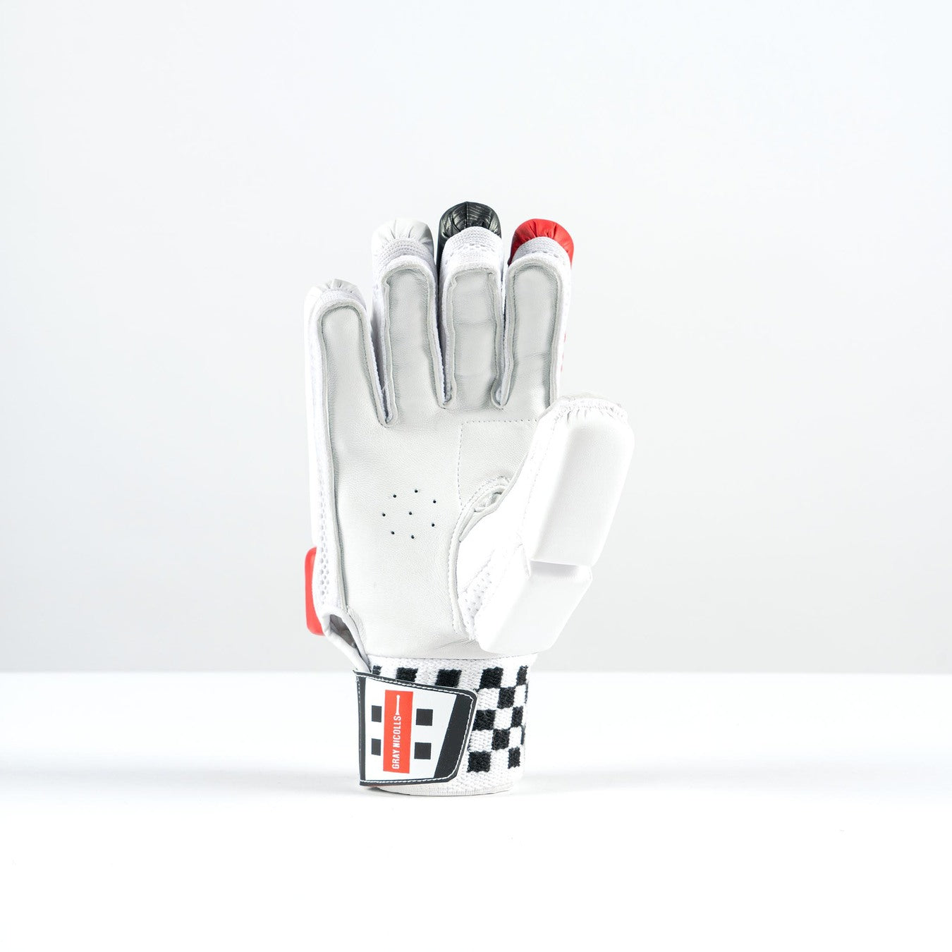 The Gray Nicolls GN PowerX Batting Gloves 2026 feature black, red, and gray accents, a black-and-white checkered wrist strap, and a red label. Shown upright with the palm forward against a plain white background.
