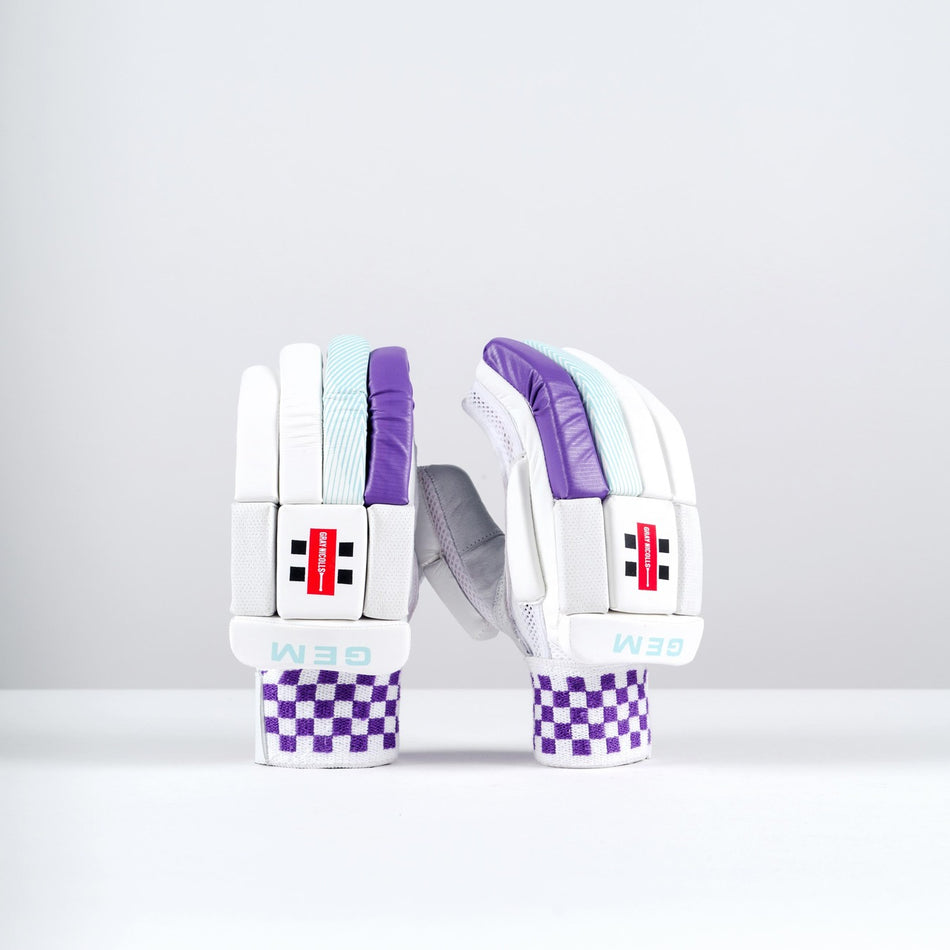 The Gray Nicolls GEM 2.1 250 Batting Gloves 2026 feature white with purple and turquoise accents, red and black branding, and purple checkered wrist straps—perfect for female club-level cricketers.