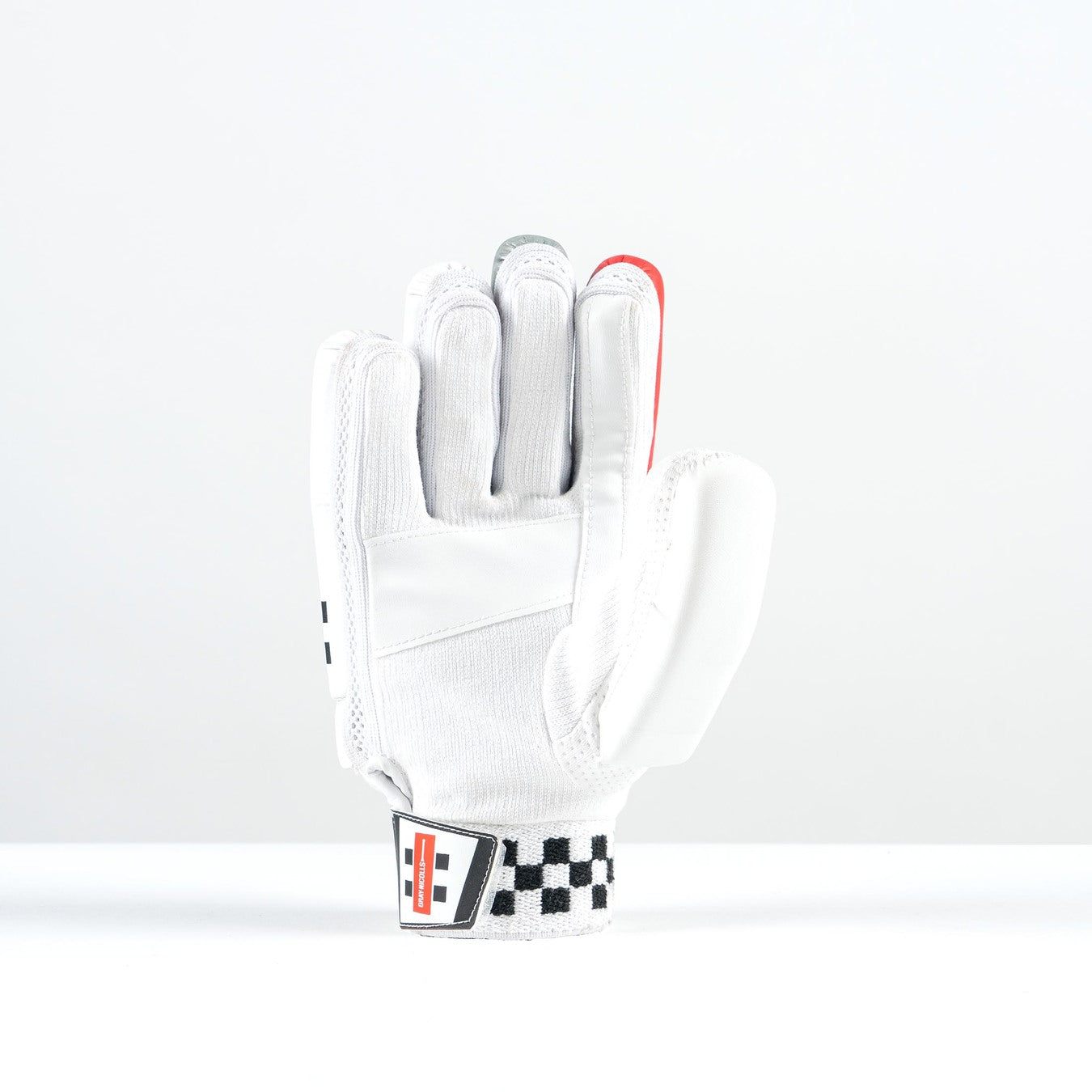 The Gray Nicolls Thunder Batting Gloves 2026, by Gray Nicolls, stand upright on a white surface. These white, lightweight gloves showcase black and red checkered wrist details and colored fingertip accents against a plain white backdrop.