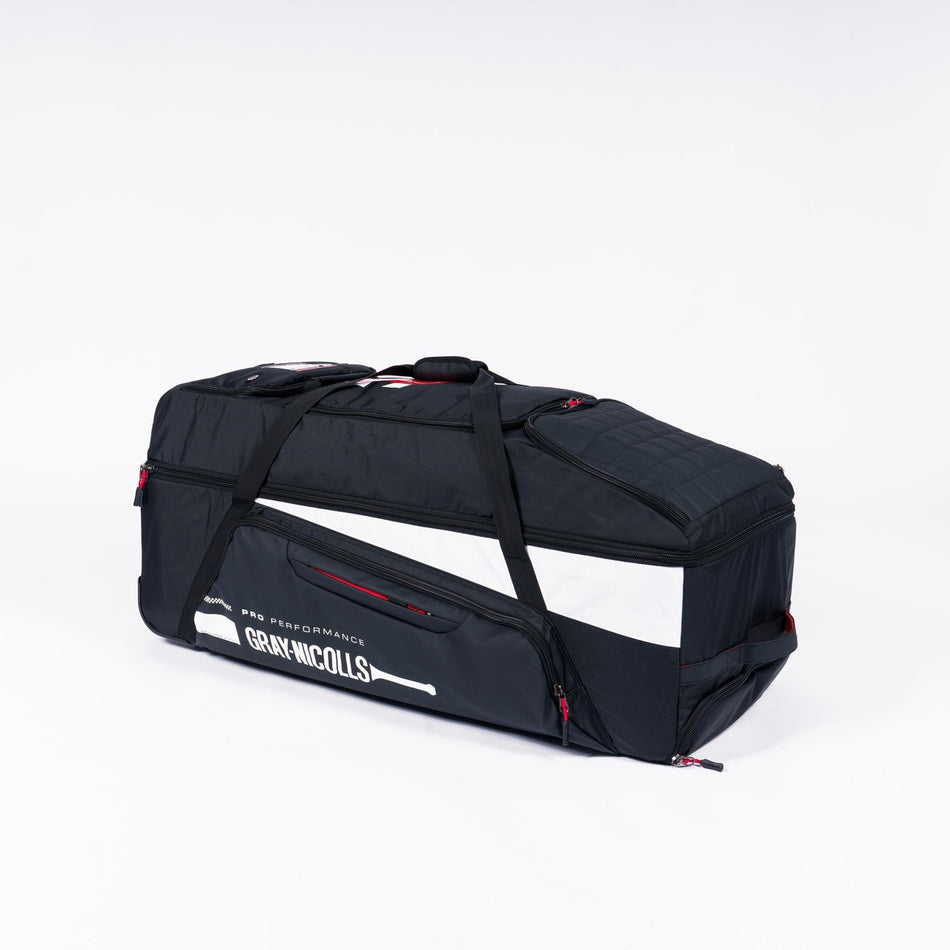 The Gray Nicolls Classic Pro Performance Wheelie 2026 kit bag, in large black with white and red accents and a top handle, displays the Gray Nicolls logo and is set against a plain white background.