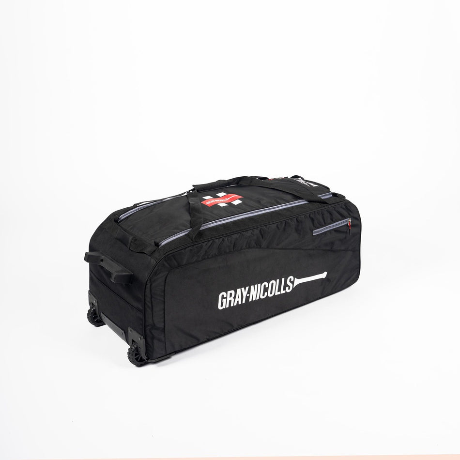 A large black Gray Nicolls Team 1000 Wheelie Bag 2026, an elite cricket kit bag with wheels, brand logo, and sturdy handle by Gray Nicolls, is placed on a white background.