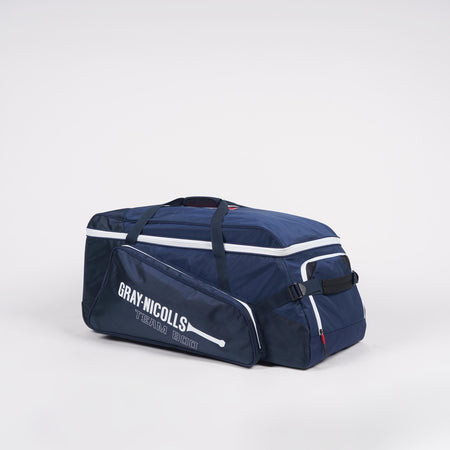 A Gray Nicolls Team 800 Wheelie cricket kit bag in navy blue with white piping, featuring large storage, zippered compartments, wheels, and carry handles, displayed against a plain white background.