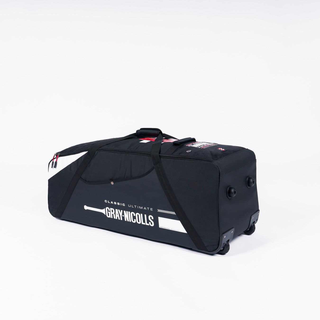 The Gray Nicolls Classic Ultimate Wheelie 2026 bag is large and black with white accents, featuring a deluxe two-wheel system and pull handle, shown on a plain white background.
